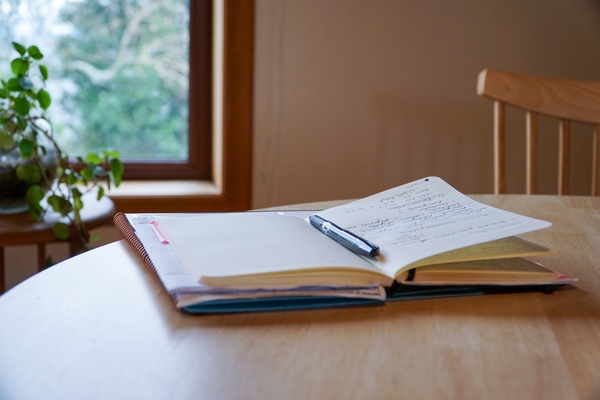 Open notebook with a pen resting on a clean page